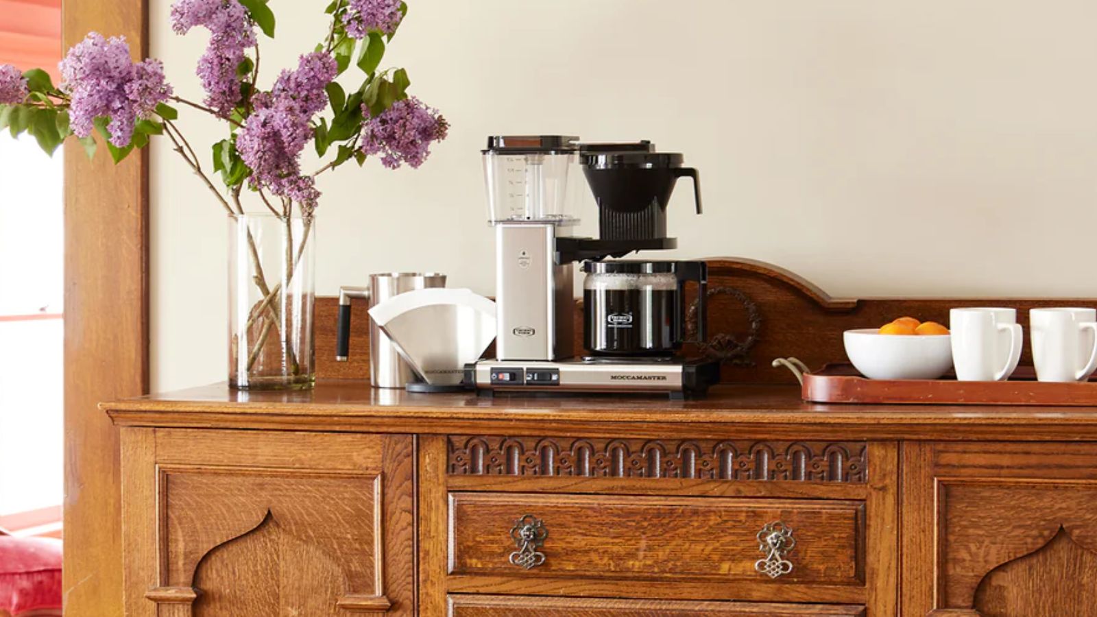 Moccamaster KBGV Select in silver on a wooden sideboard