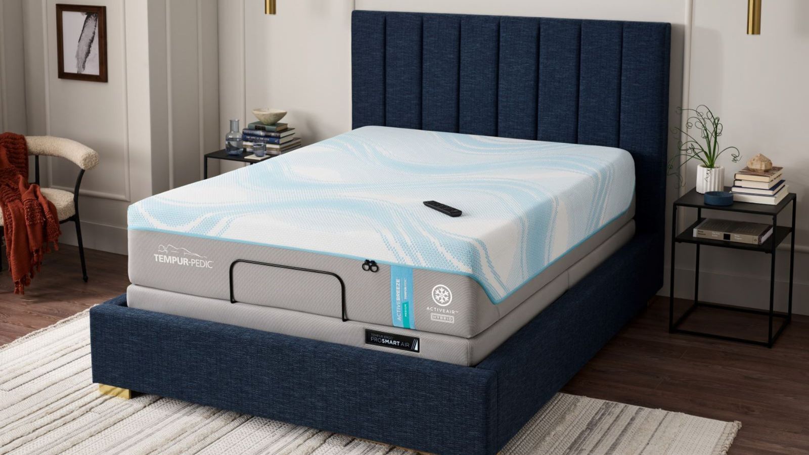 A Tempur-Pedic mattress on a bed frame against white walls. 