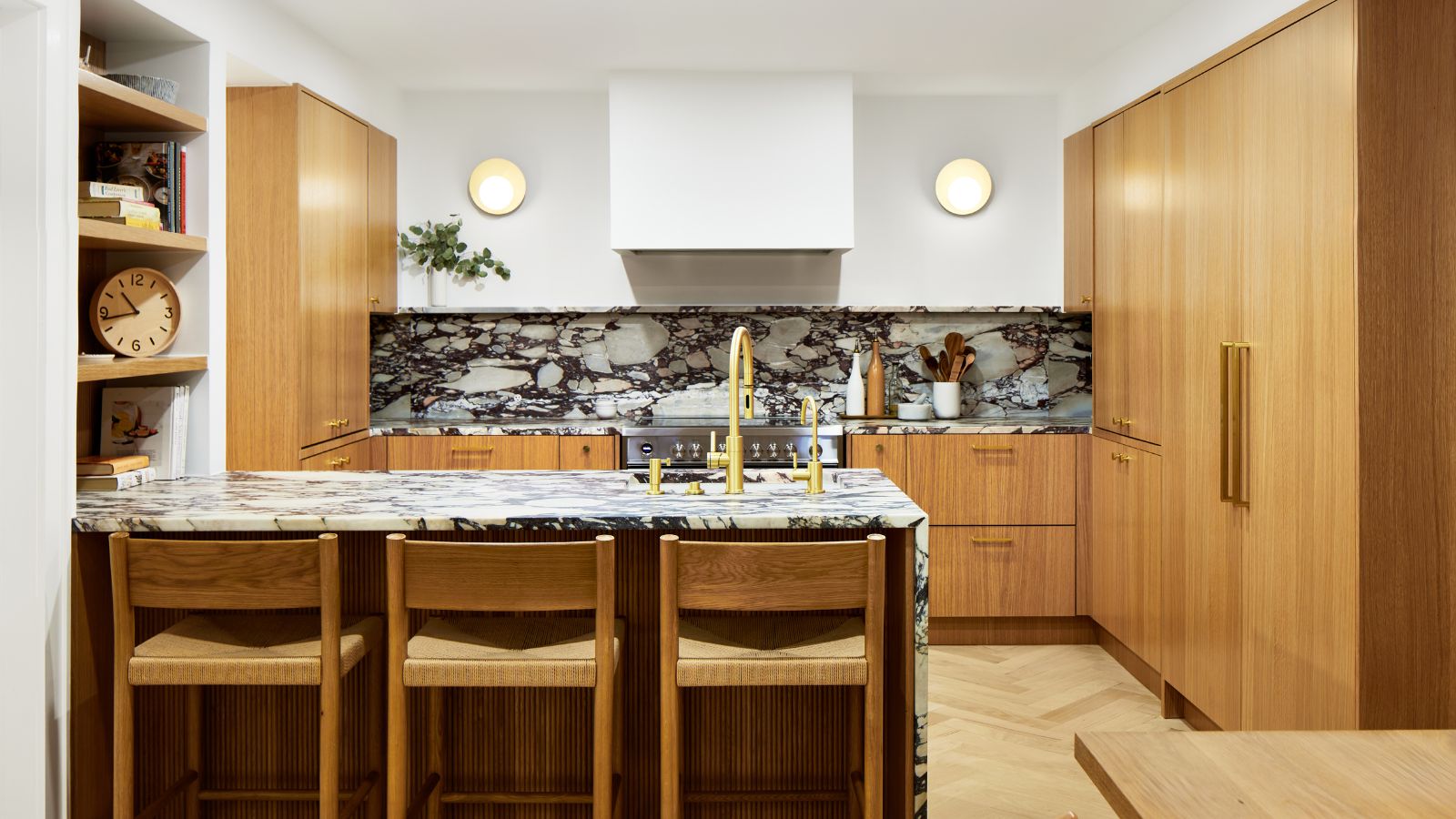 Wooden kitchen with marble countertops and backsplash and white walls