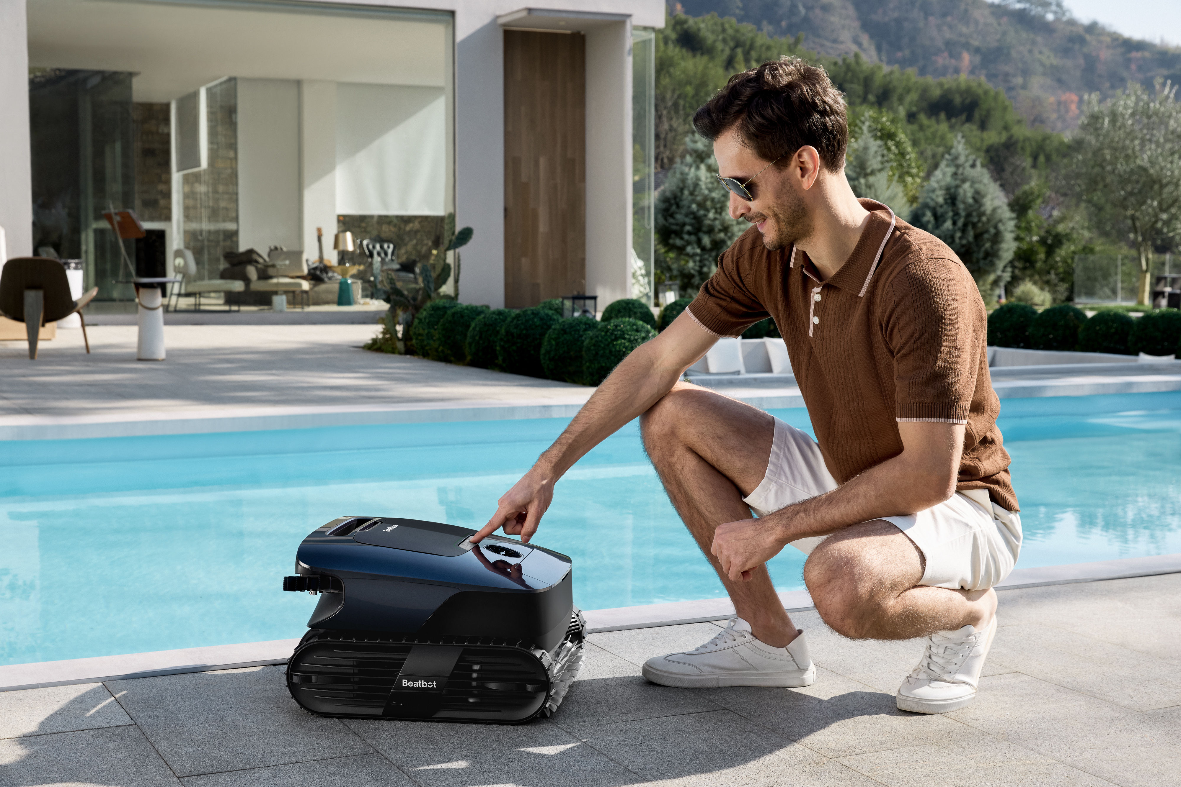 Beatbot AquaSense 2 Ultra owners relaxing while the robotic pool cleaner clears the pool.