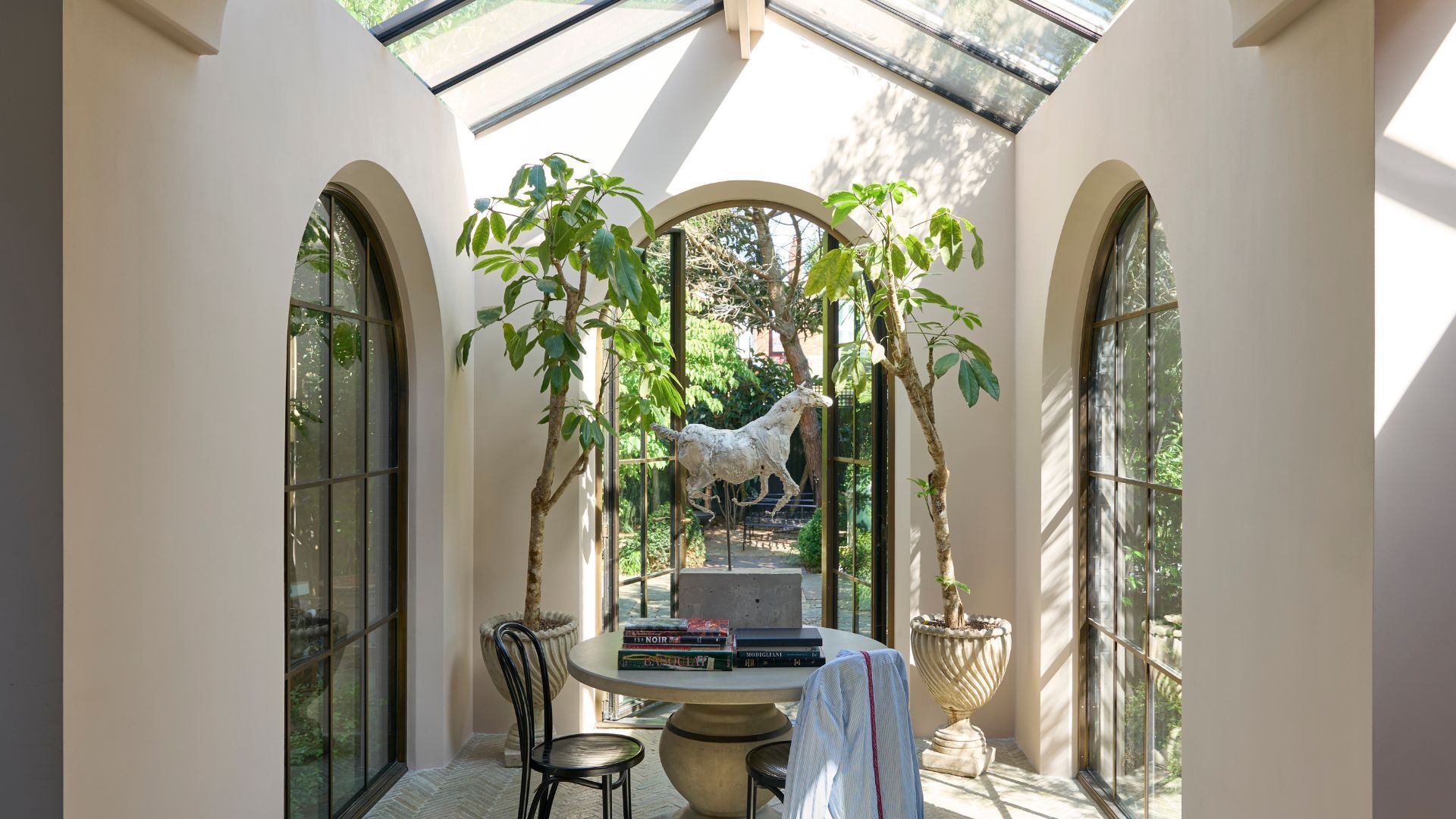 A light filled orangery with creamy, pale blush walls