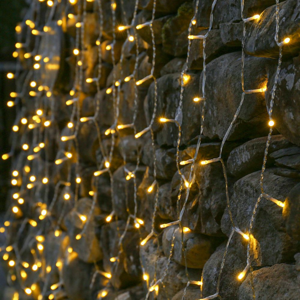 Curtain lights strung up on a stone wall
