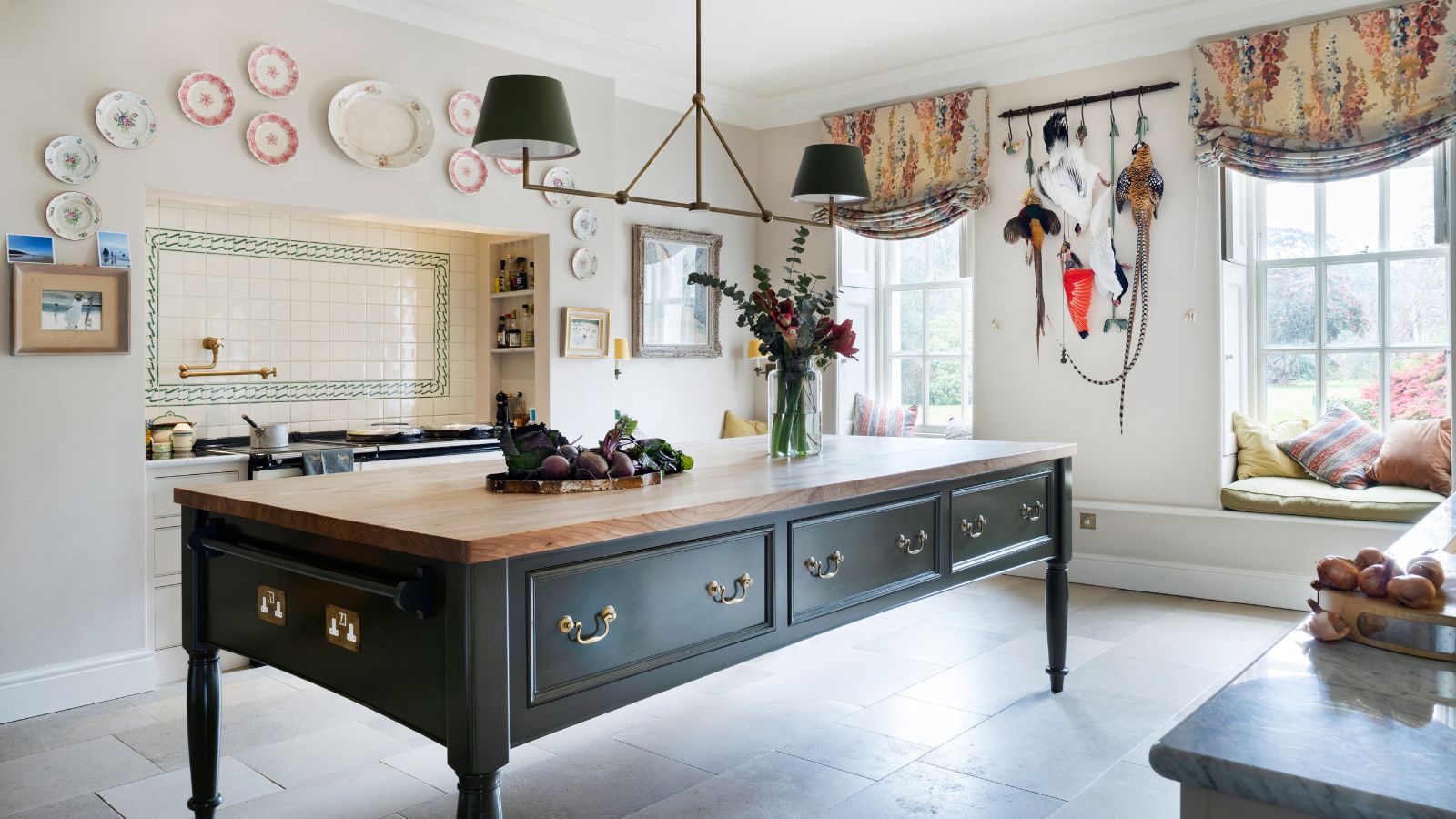 A green freestanding kitchen island takes pride of place in a country kitchen